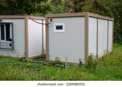 Modular Housing In Stacked Container Cells. Each Module Has A Different Function. Part Is A Stair Toilet, Office Kitchen And Air Conditioning On The Wall. Connected Power Cables In The Socket