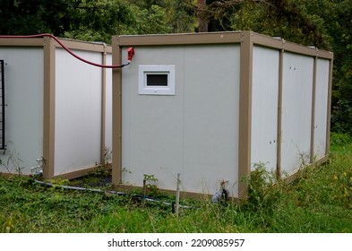 Modular Housing In Stacked Container Cells. Each Module Has A Different Function. Part Is A Stair Toilet, Office Kitchen And Air Conditioning On The Wall. Connected Power Cables In The Socket