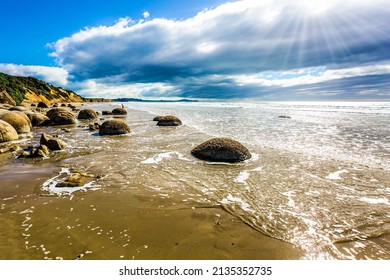 Moeraki Boulders is the group of large spherical boulders. The South Island of New Zealand. Popular tourist attraction. Low tide in the Pacific ocean. The concept of exotic and ecological tourism - Shutterstock ID 2135352735