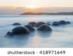 Moeraki Boulders on the Koekohe beach, New Zealand during sunrise (long exposure)