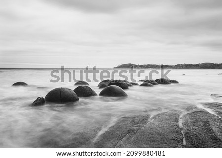 Moeraki Boulders on the Koekohe beach. Eastern coast of New Zealand. HDR image, black and white