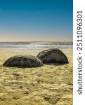 The Moeraki Boulders are unusually large spherical boulders lying along a stretch of Koekohe Beach on the wave-cut Otago coast of New Zealand between Moeraki and Hampden.