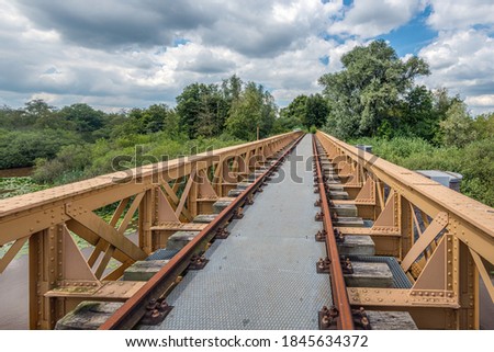 The Moerputten Bridge is a former Dutch railway bridge. It was in use as railway bridge from 1887 until 1972. Currently the restored bridge is a footpath through and above a nature reserve.