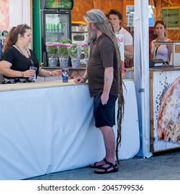 Mogyorod,Pest \ Hungary 07.30.2021 - Man With Very Long Hair Buys Some Food