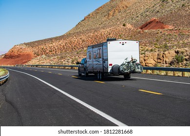 Mohave Desert By Route 66. RV Camping, Camper Van On Road. Caravan Or Recreational Vehicle Motor Home Trailer On A Mountain Road In America