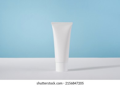 Moisturiser Hand Cosmetic Cream White Plastic Tube Mockup On Blue Background Front View. Blank Body And Health Care Beauty Product Packaging. Hand Cream Bottle