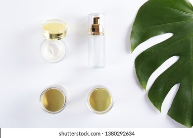 Moisturizing care skincare face cream for healing complicated troubled skin type in an open jar with visible texture. Copy space, close up, background, flat lay, top view. Monstera leaf decoration.