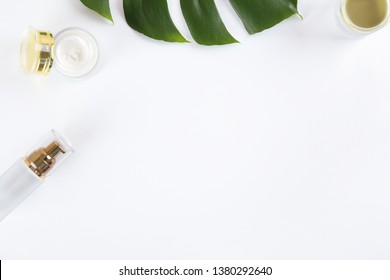 Moisturizing care skincare face cream for healing complicated troubled skin type in an open jar with visible texture. Copy space, close up, background, flat lay, top view. Monstera leaf decoration.