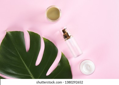 Moisturizing care skincare face cream for healing complicated troubled skin type in an open jar with visible texture. Copy space, close up, background, flat lay, top view. Monstera leaf decoration.