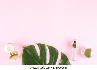 Moisturizing care skincare face cream for healing complicated troubled skin type in an open jar with visible texture. Copy space, close up, background, flat lay, top view. Monstera leaf decoration.
