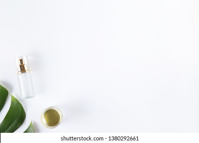 Moisturizing care skincare face cream for healing complicated troubled skin type in an open jar with visible texture. Copy space, close up, background, flat lay, top view. Monstera leaf decoration.