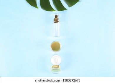Moisturizing care skincare face cream for healing complicated troubled skin type in an open jar with visible texture. Copy space, close up, background, flat lay, top view. Monstera leaf decoration.