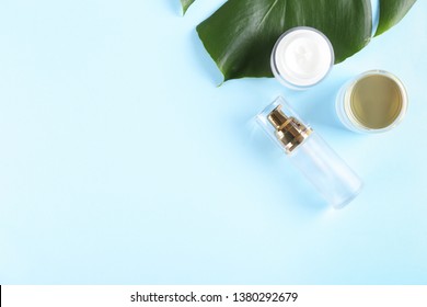 Moisturizing care skincare face cream for healing complicated troubled skin type in an open jar with visible texture. Copy space, close up, background, flat lay, top view. Monstera leaf decoration.
