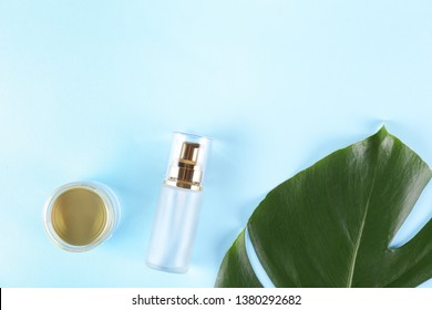 Moisturizing care skincare face cream for healing complicated troubled skin type in an open jar with visible texture. Copy space, close up, background, flat lay, top view. Monstera leaf decoration.