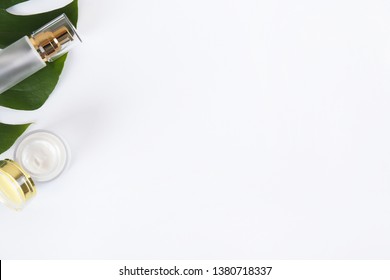 Moisturizing care skincare face cream for healing complicated troubled skin type in an open jar with visible texture. Copy space, close up, background, flat lay, top view. Monstera leaf decoration.