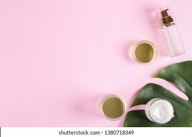Moisturizing care skincare face cream for healing complicated troubled skin type in an open jar with visible texture. Copy space, close up, background, flat lay, top view. Monstera leaf decoration.