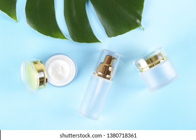 Moisturizing care skincare face cream for healing complicated troubled skin type in an open jar with visible texture. Copy space, close up, background, flat lay, top view. Monstera leaf decoration.