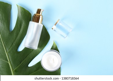 Moisturizing care skincare face cream for healing complicated troubled skin type in an open jar with visible texture. Copy space, close up, background, flat lay, top view. Monstera leaf decoration.