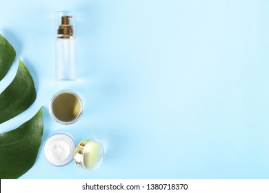 Moisturizing care skincare face cream for healing complicated troubled skin type in an open jar with visible texture. Copy space, close up, background, flat lay, top view. Monstera leaf decoration.