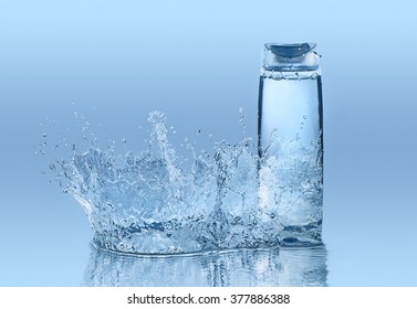 Moisturizing Shampoo On The Blue Water Background With Big Splash Around The Bottle