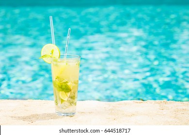 Mojito Cocktail At The Edge Of A Resort Pool. Concept Of Luxury Vacation. Outdoor Pool Background. Horizontal