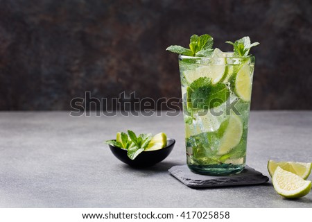 Mojito cocktail with lime and mint in highball glass on a grey stone background Copy space 商業照片 © 