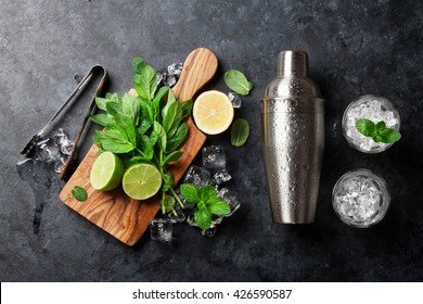Mojito cocktail making. Mint, lime, ice ingredients and bar utensils. Top view