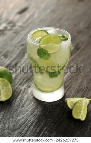 Mojito Drink Lime Soda with Mint Leaf,  Ice Cold Summer Beverage on Wooden Table 