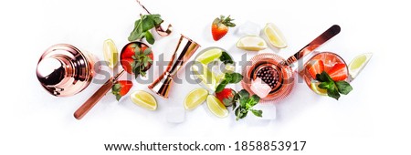 Mojito mocktail set with lime, mint, strawberry and ice on white background. Cold alcoholic non-alcoholic long drinks, beverages and cocktails