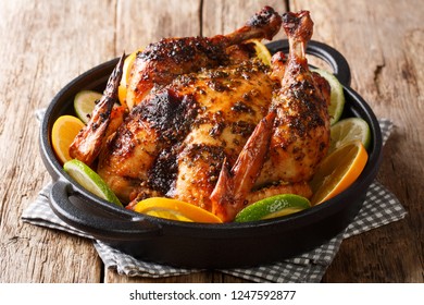 Traditional Cuban Mojo Chicken dish Baked And Served With Fresh Oranges And Limes Closeup In A Pan On The Table. Horizontal
