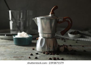 Moka pot, coffee beans and sugar cubes on rustic wooden table - Powered by Shutterstock