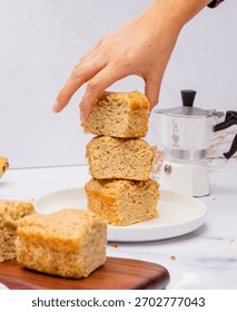 A moka pot and a stack of cake slices