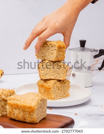 A moka pot and a stack of cake slices