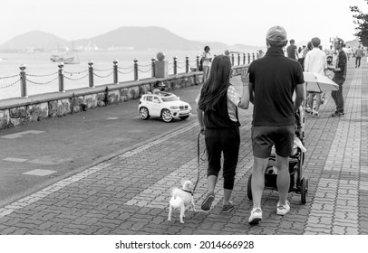 MOKPO, KOREA, SOUTH - Jun 10, 2015: A Grayscale Shot Of South Korean Family Walking Beside The Gatbawi Park In Mokpo City