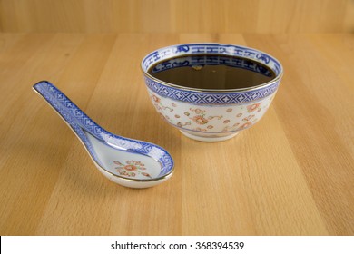 Molasses In Porcelain Bowl With Porcelain Spoon.