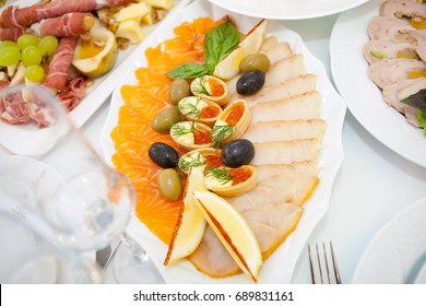 Mold fish, smoked fish, red roe and olives in a plate