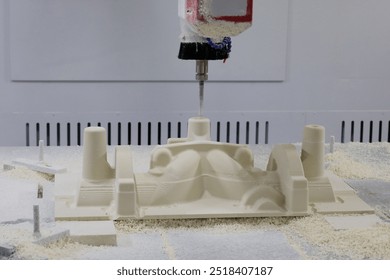 Mold making process from epoxy tooling board on a CNC router machine. Selective focus.