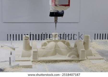 Mold making process from epoxy tooling board on a CNC router machine. Selective focus.