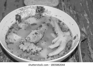 Moldavian borscht with a rooster's head and a cock's paw close-up on a table in black and white - Shutterstock ID 1805882044