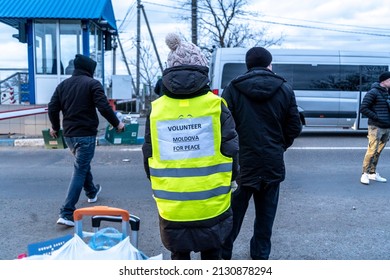moldavian ukrainian border - 02 28 2022: moldavian volunteer on the border waiting to help ukrainian refugees, with words on the back moldova for peace