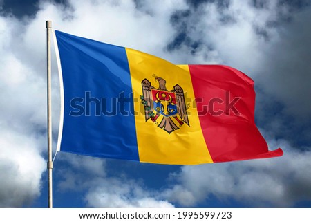 Moldova flag on sky and cloud background. National symbols of Moldova. Flag of Moldova.