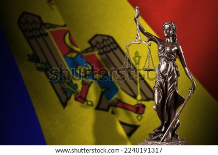 Moldova flag with statue of lady justice and judicial scales in dark room. Concept of judgement and punishment, background for jury topics