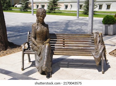 Moldova. Kishinev. 06.19.22. Sculpture of a woman sitting on a park bench.