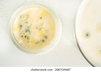 Moldy Food, Top View Of Closeup Rotten Moldy Yogurt Or Yoghurt In Jar On Wooden Background. Rotten Dairy Product Or Milk On Table