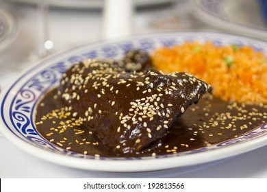 Mole Poblano with steamed red rice served in a Talavera plate