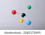 Molecular atom model on light grey background. Chemical structure