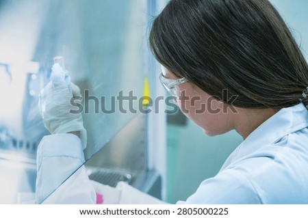 Molecular biologist executing qpcr amplification protocols using micropipette. Genomic researcher preparing dna sequencing samples in sterile biosafety cabinet.