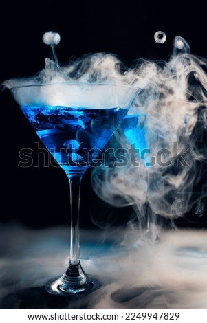molecular cuisine. Glass of blue drink and steam