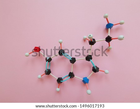 Molecular structure model of serotonin molecule. Serotonin is a monoamine neurotransmitter, and it is also called Hormone of Happiness. Black=C, red=O, blue=N, white=H.
