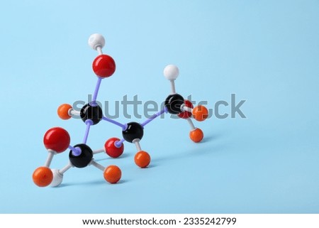 Molecule of sugar on light blue background, space for text. Chemical model